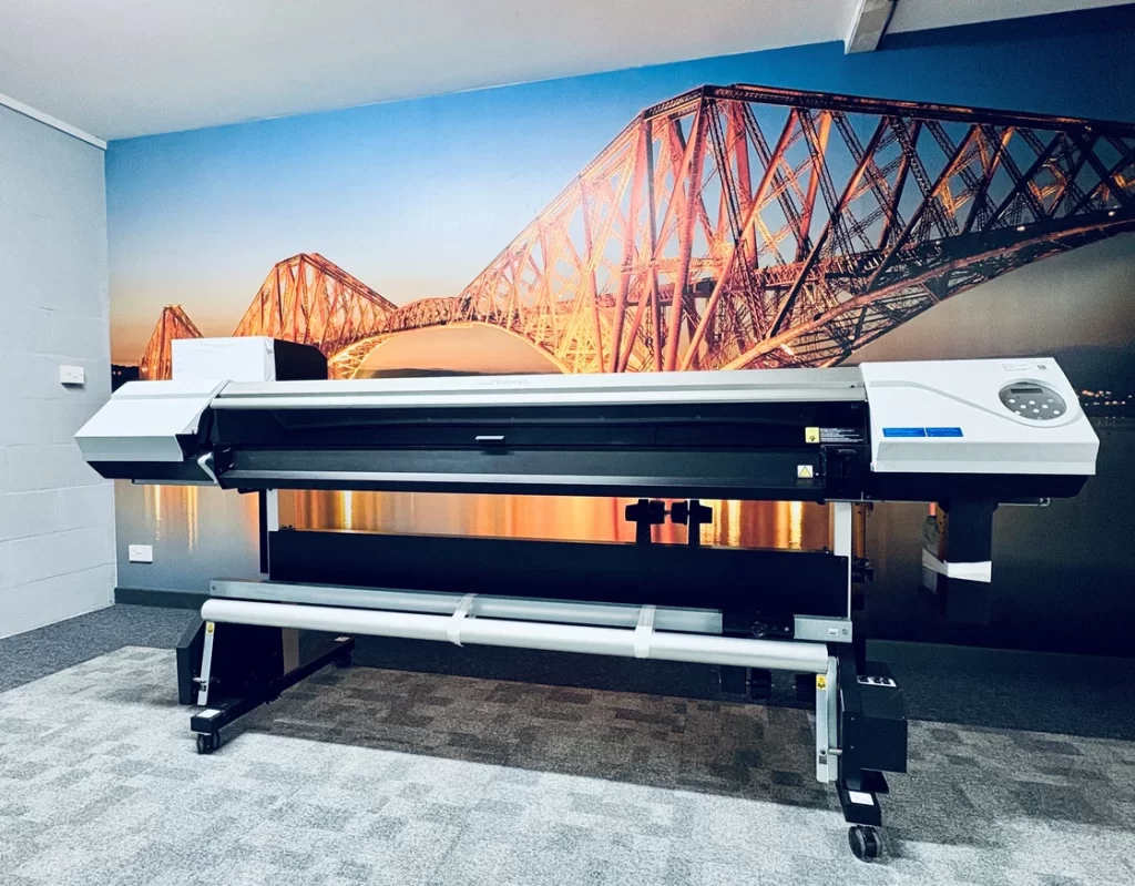 Image of new wide format printer in front of printed wallscape.